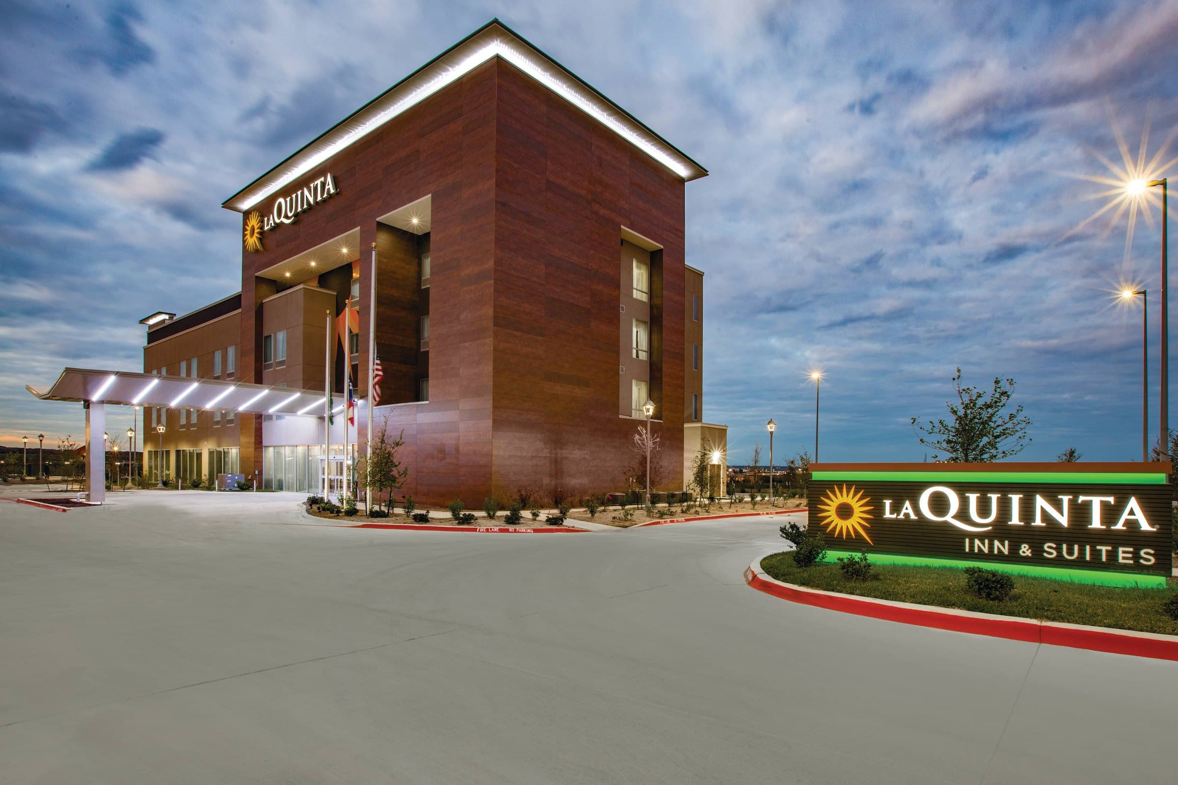 Hotel exterior at dusk with the lit entrance canopy
